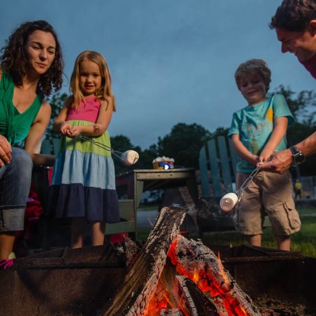 happy family around campfire